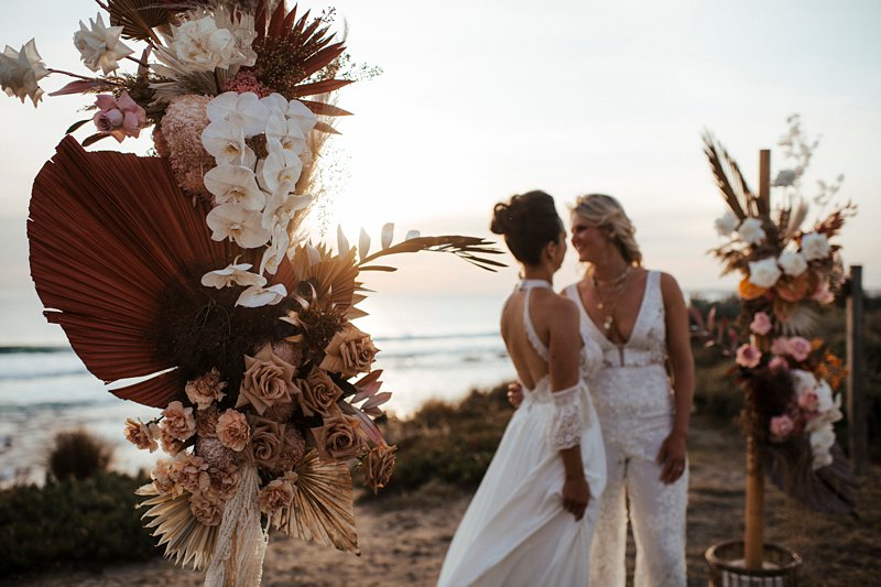 Rust and peach dried wedding flowers, Beachside styled wedding set up, sunpalms, same sex styled wedding