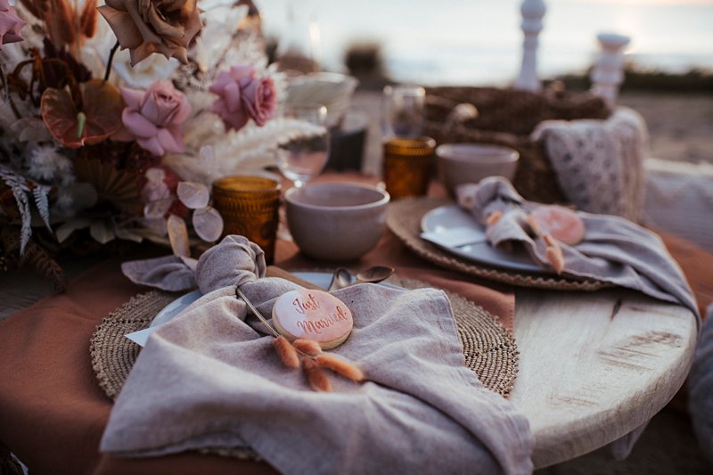 beachside clifftop wedding feast, wedding sunset picnic, sunset wedding, boho styled wedding feast, rust tones wedding